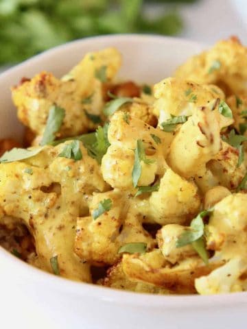 Indian cauliflower and roasted chickpeas in white bowl