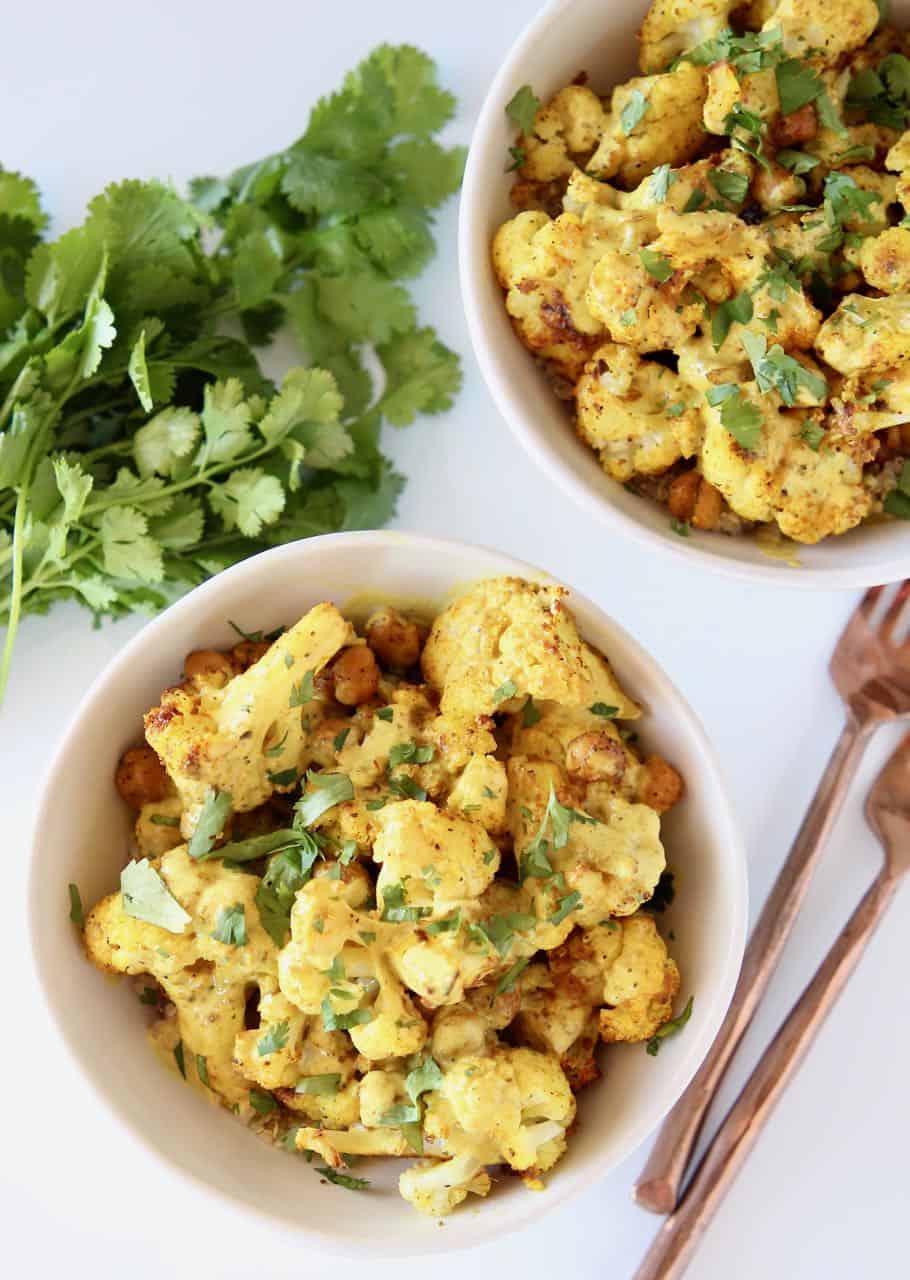 Indian spiced cauliflower in bowls with yellow curry sauce