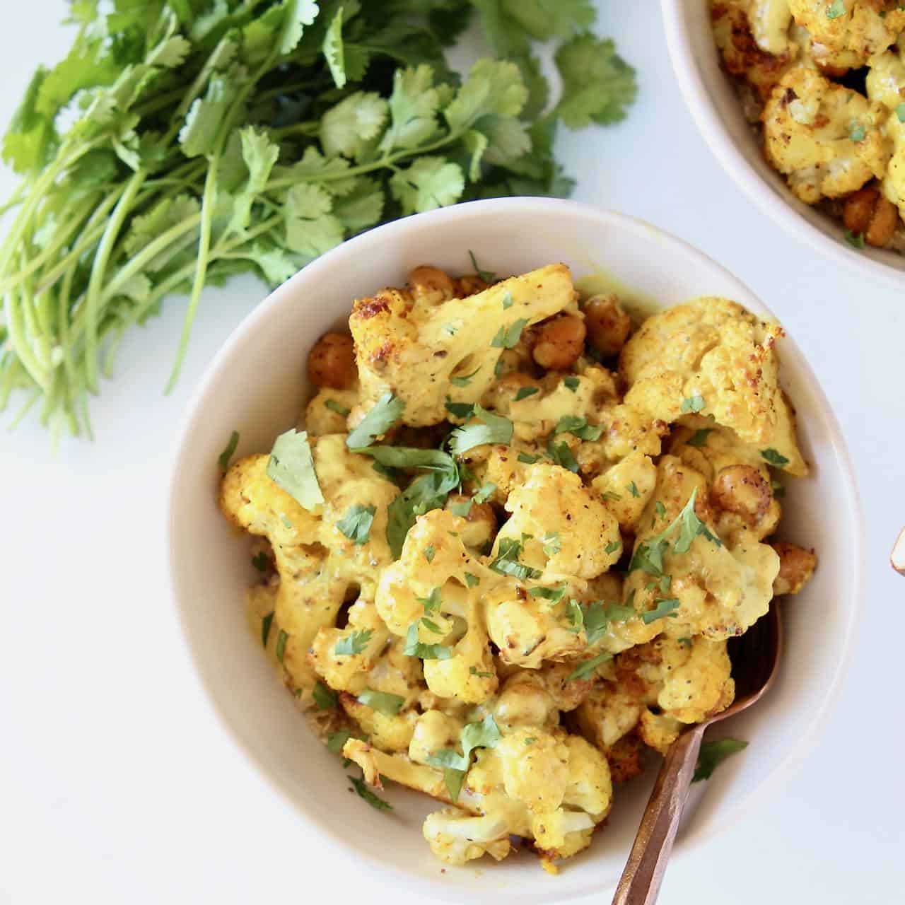 Indian cauliflower in bowl with roasted chickpeas and cilantro
