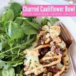 Cauliflower and arugula in bowl with fork