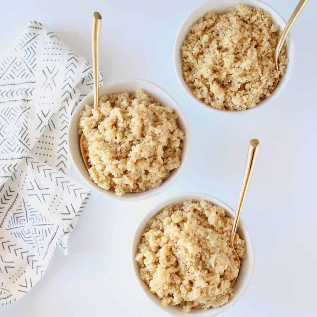 quinoa in three bowls with gold forks
