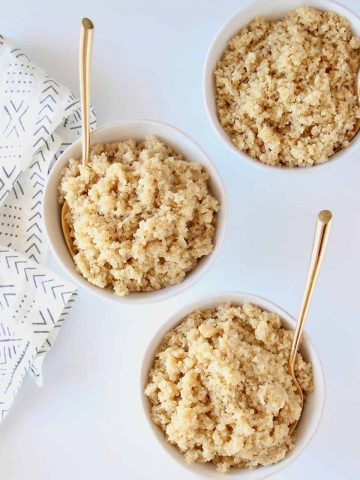 quinoa in three bowls with gold forks