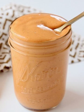 Chipotle sauce in mason jar with small gold spoon