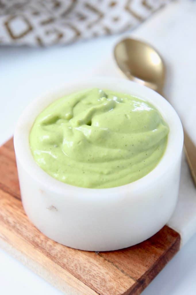 Creamy avocado sauce in small white bowl