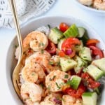 Image of shrimp in bowl with tomato cucumber salad, with text overlay
