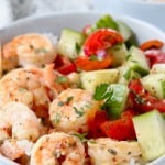 Image of shrimp in bowl with tomato cucumber salad, with text overlay