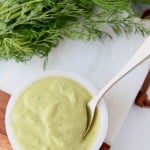 Creamy poblano ranch dressing in white bowl with small gold spoon