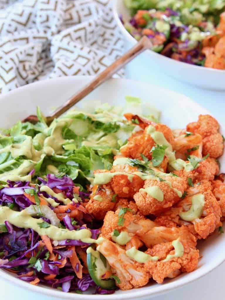 Buffalo cauliflower in bowl with cabbage and lettuce