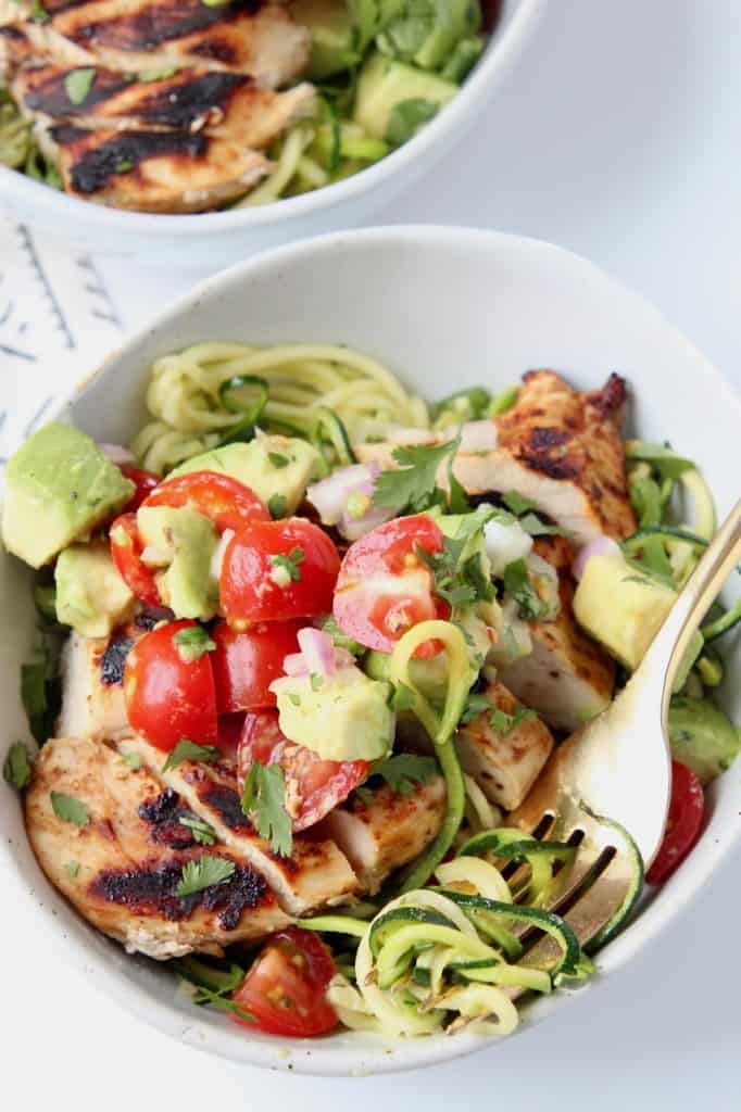 Grilled chicken in bowl with zucchini noodles and fork