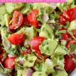 Avocado and tomato salsa in bowl with gold spoon