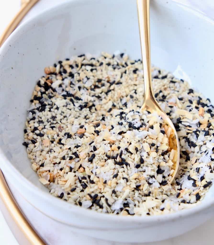 Everything bagel seasoning in bowl with gold spoon