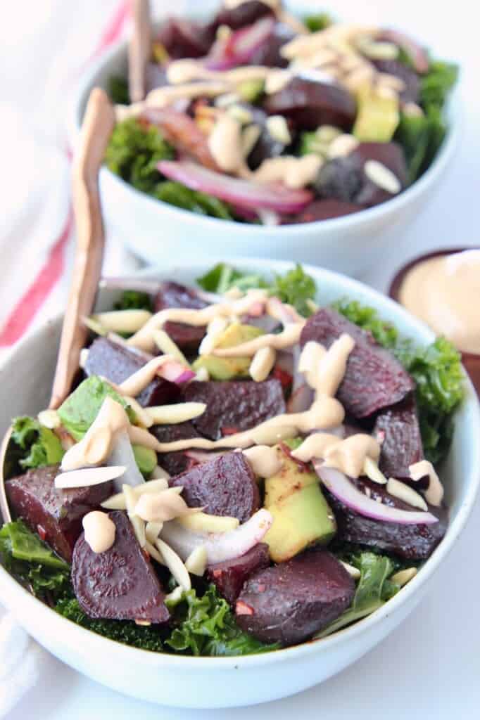 Roasted beet kale salad in bowl with fork