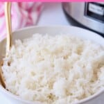White rice in bowl with gold spoon