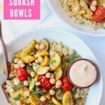 Overhead image of roasted vegetables and quinoa in bowl with fork