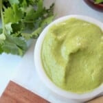Overhead image of cilantro sauce in bowl and on spoon