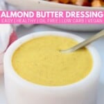 almond butter turmeric dressing in small white bowl with spoon