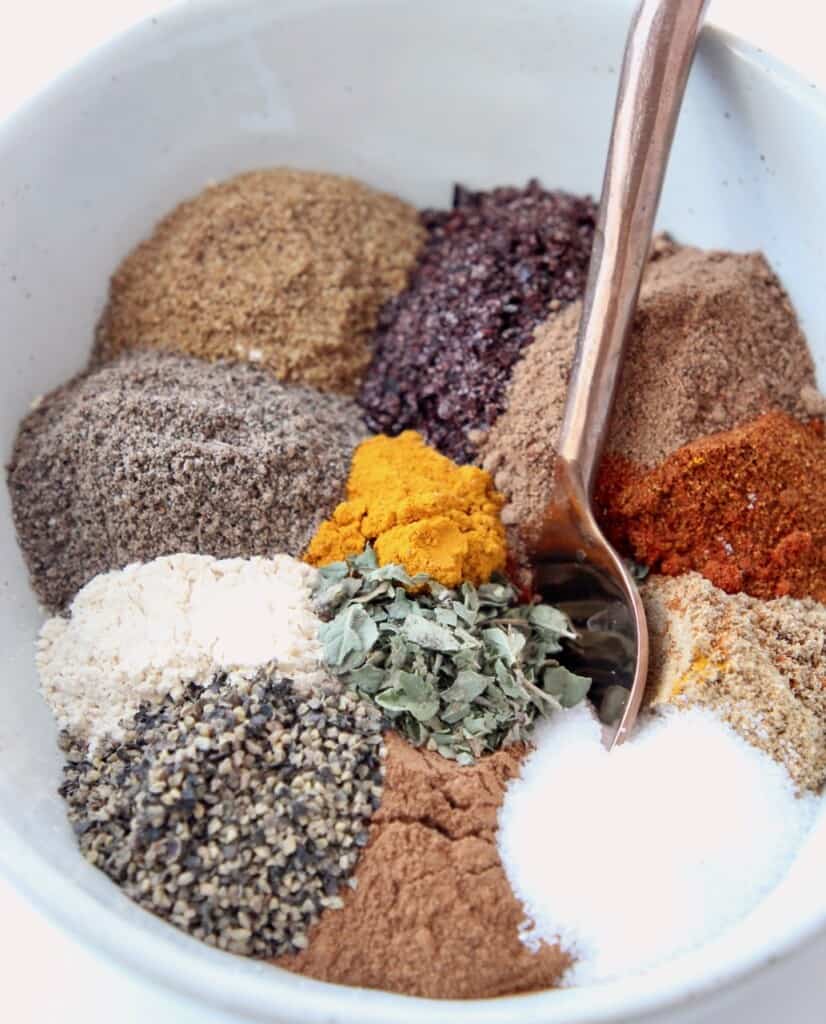 spices in bowl with copper spoon