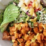 overhead image of roasted sweet potato salad in bowl with fork