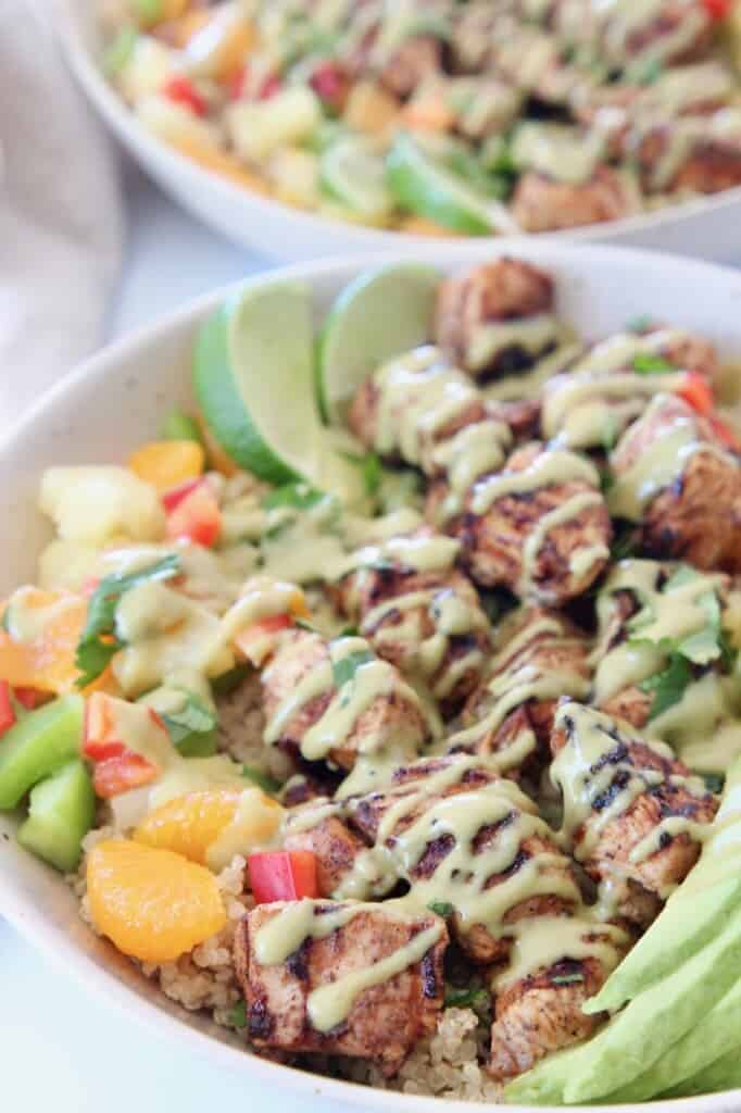 grilled chicken pieces in bowl drizzled with honey lime dressing