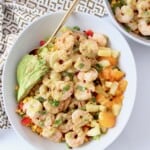 cooked shrimp in salad bowl topped with honey lime dressing