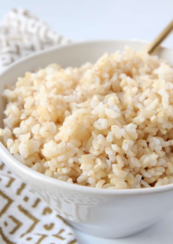 cooked brown rice in white bowl