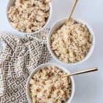 overhead image of 3 bowls of cooked brown rice with gold spoons
