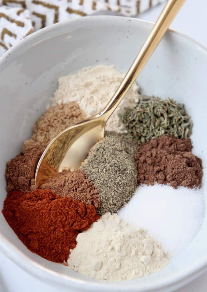 spices in bowl with gold spoon