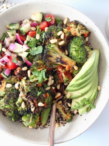 roasted broccoli in bowl with diced cucumber, tomato and avocado