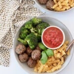 vegan meatballs in bowl with broccoli, rotini and marinara sauce