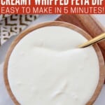 creamy whipped feta dip in wooden bowl with spoon