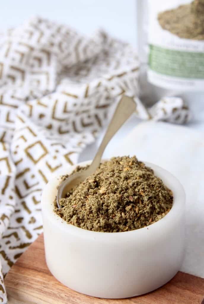 zaatar seasoning blend in small white bowl with spoon