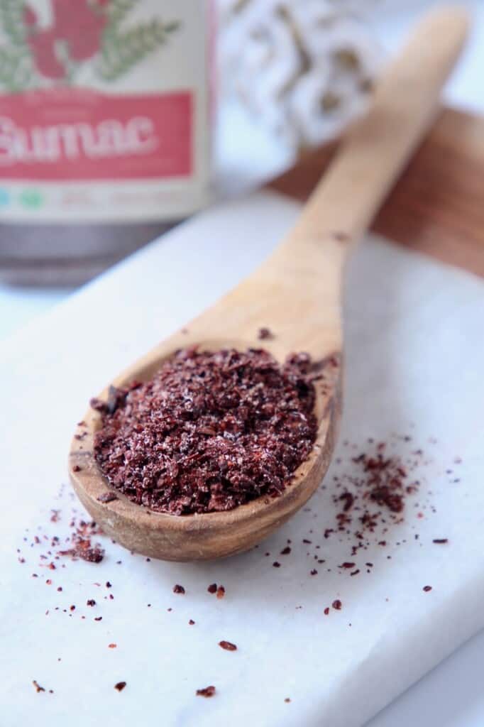 sumac spice in wooden spoon