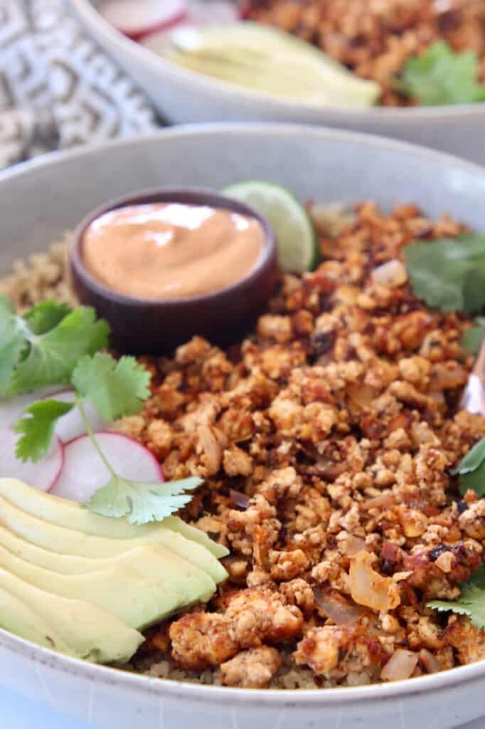 crumbled tofu taco meat in bowl with avocado and creamy chipotle sauce