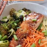 teriyaki glazed salmon in bowl with carrots, broccoli and avocado