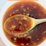 teriyaki sauce in small white bowl with small gold spoon