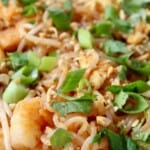 shrimp pad thai in bowl topped with green onions
