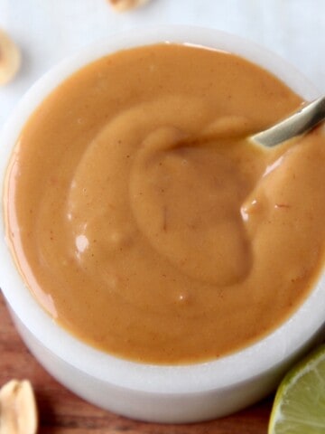 peanut sauce in white bowl with small spoon