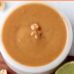 peanut sauce in bowl with sliced lime on the side
