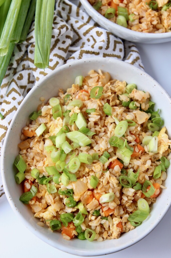 fried rice in bowl topped with diced green onions