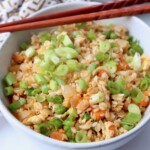 fried rice in white bowl with chopsticks on the side