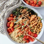 quinoa and roasted vegetables in bowl drizzled with sauce