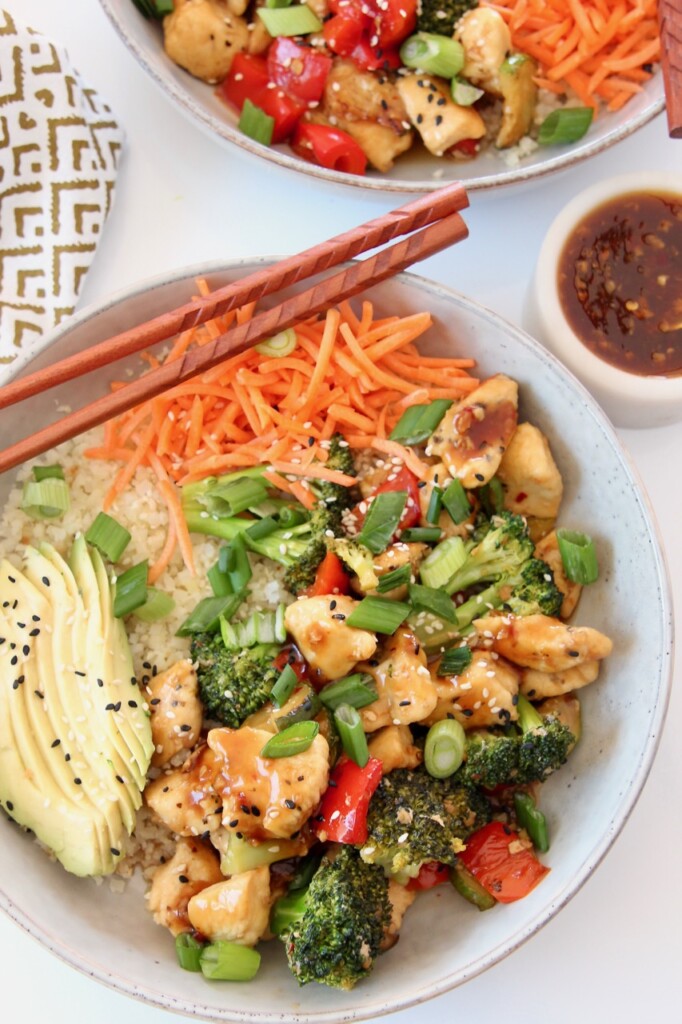 chicken teriyaki bowl with vegetables and chop sticks