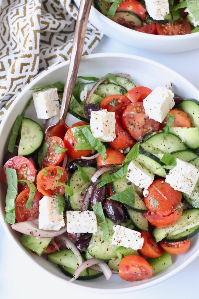 greek salad in bowl with fork