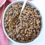 cooked lentils in bowl with spoon