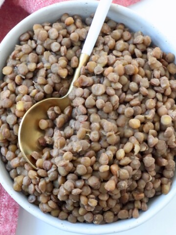cooked lentils in bowl with spoon