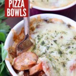 pizza bowls with sliced sausage and mushrooms covered with melted cheese with fork in the bowl