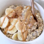 oats in bowl with sliced bananas and peanut butter