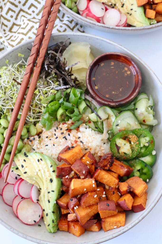 vegan poke bowl with chopsticks on the side of the bowl