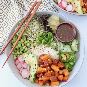 poke bowl with diced sweet potatoes and chopsticks on the side of the bowl
