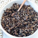 cooked wild rice in bowl with copper fork